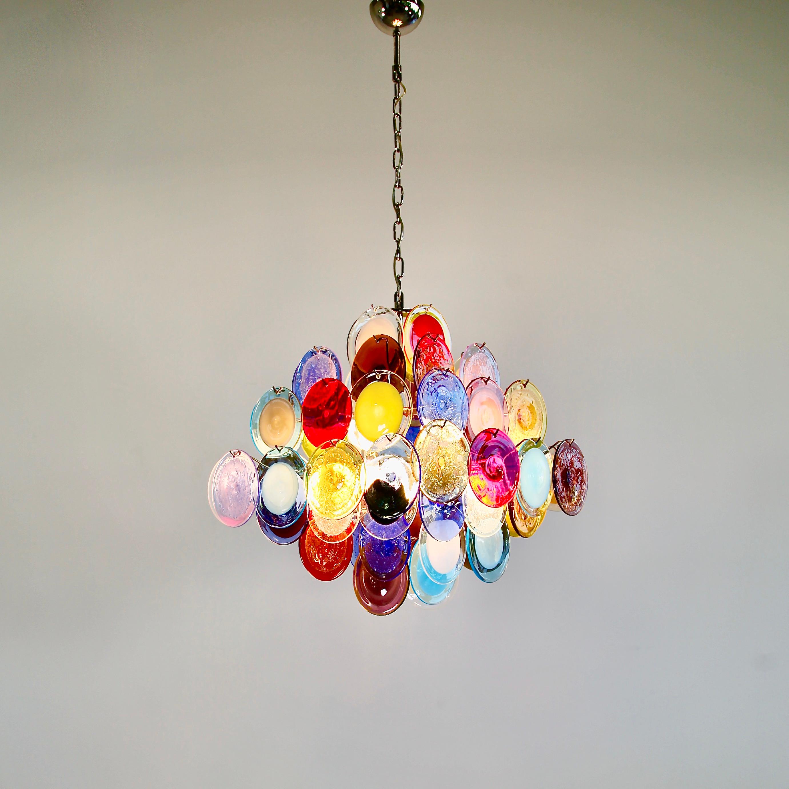 Large glass disk chandelier. Italy, Murano.

Chandelier with multicolored glass disks, hand blown in Murano. Metal frame with ten light sockets.