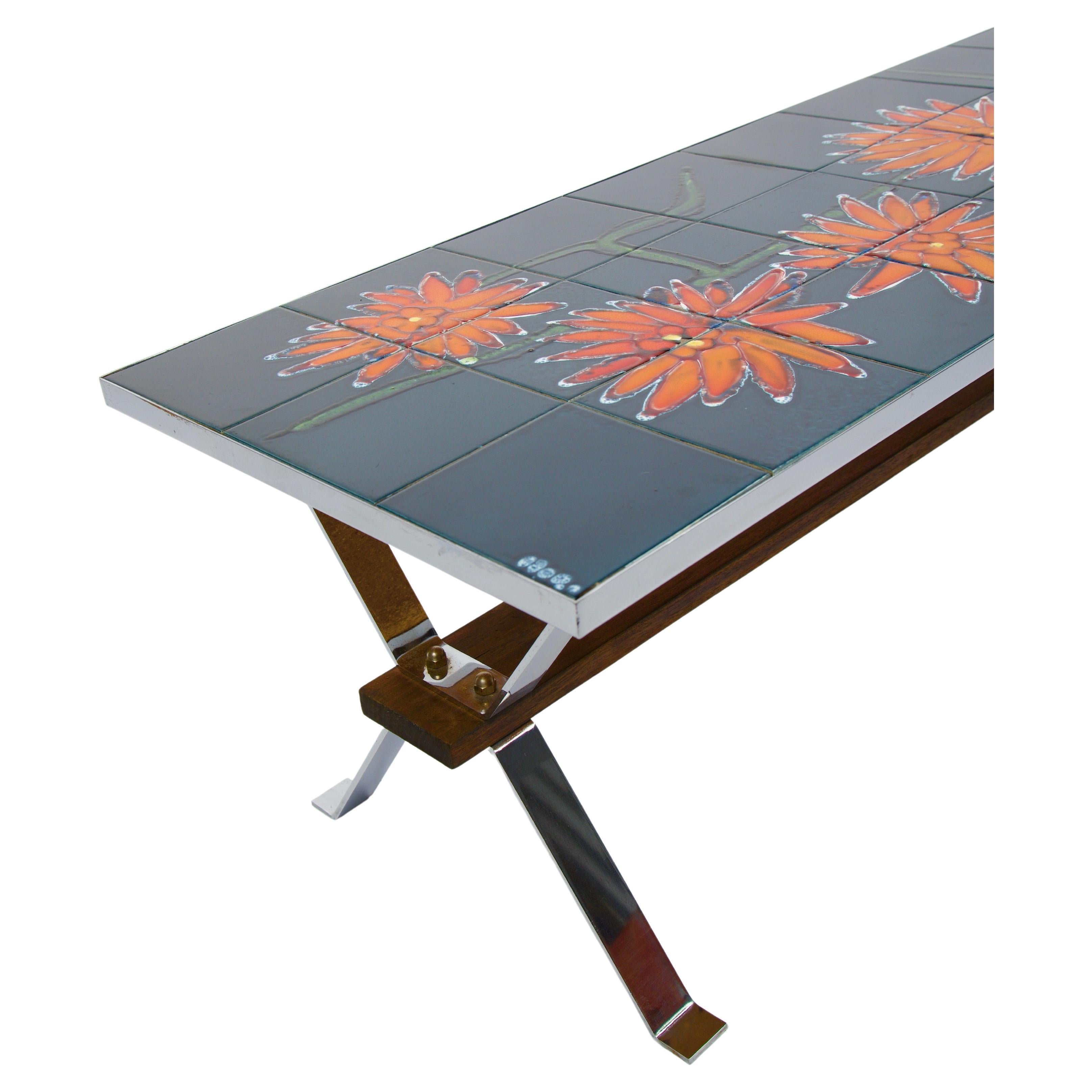 This tile-top coffee table with chrome legs was a popular design in mid-century Europe. This table features a rectangular blue ceramic tile with large orange abstract hand painted flowers. 

 The tile-top coffee table with chrome legs perfectly