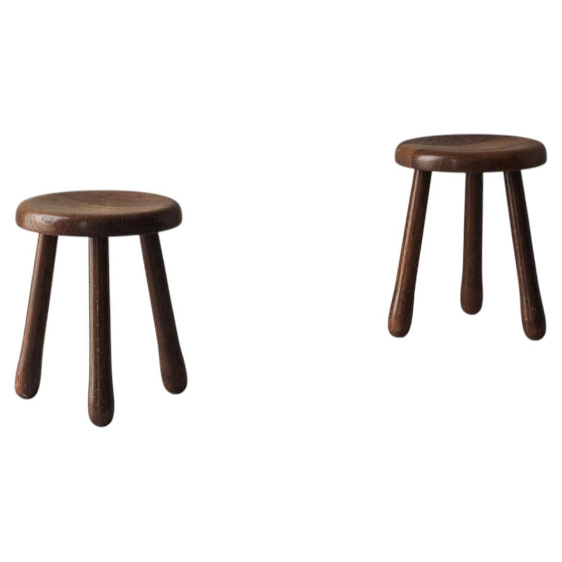 Set of two tripod solid elm stools from France, dating to the 1960s
