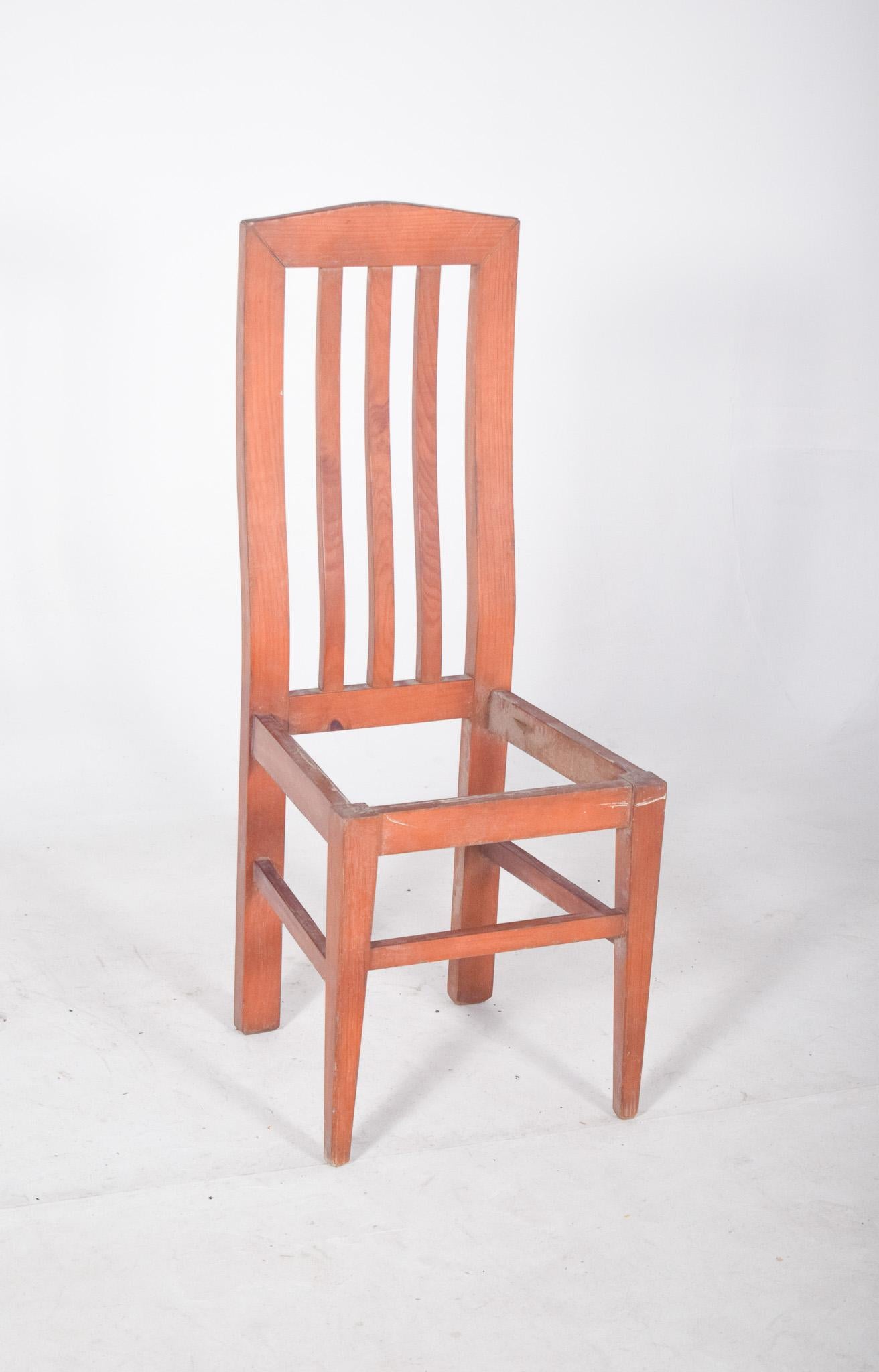 Chaise à dossier haut. Le dos est constitué de quatre lamelles verticales légèrement incurvées, ce qui lui confère légèreté et design moderne. La partie supérieure du dossier présente une coupe légèrement arquée, qui ajoute une touche d'élégance à