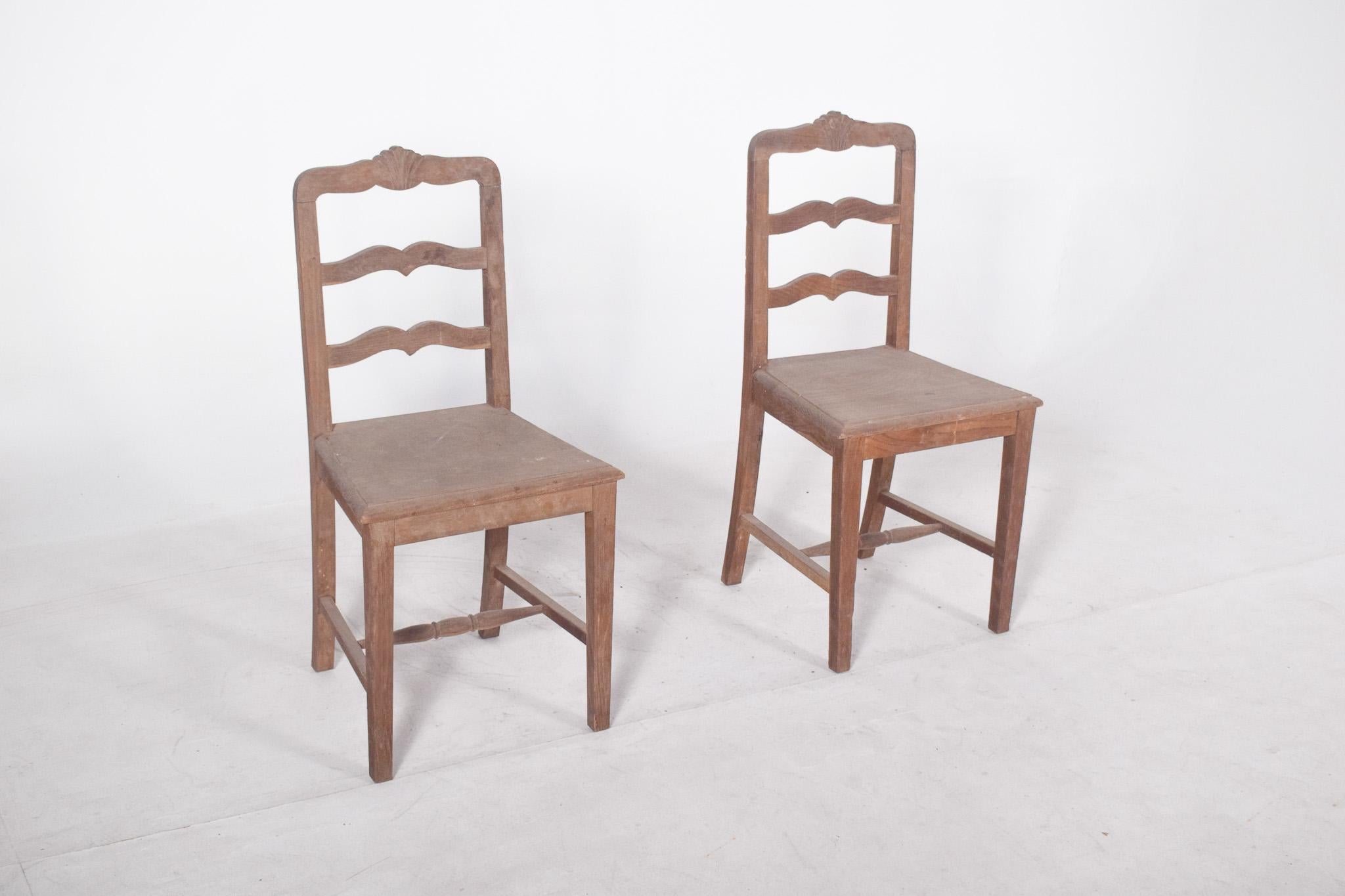 Coppia di sedie a fiori. Realizzato in legno massiccio con un design tradizionale, forse di origine rurale o in stile coloniale brasiliano, con uno schienale composto da tre doghe orizzontali ricurve, la cui parte superiore è decorata con un