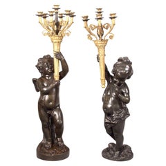 Paar vergoldete und patinierte Putti-Fackeln aus Bronze