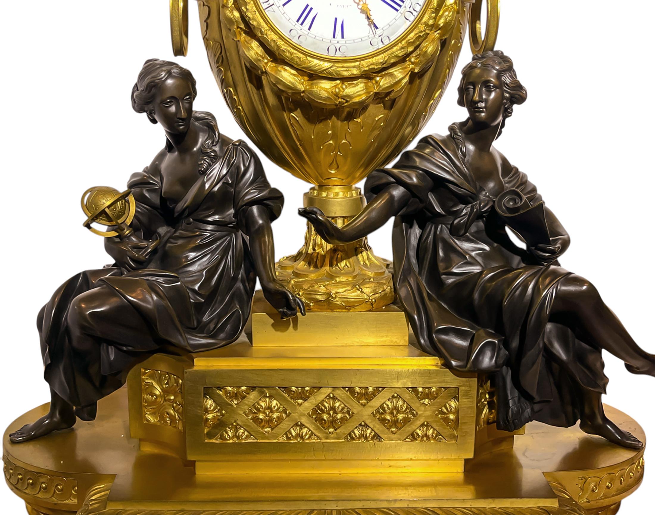 An ovoid gilt bronze urn adorned with cast swagged garlands, bows and acanthus leaves housing a white enamel clock face with Roman hours and Arabic minutes and marked ‘De La Fontaine Paris. The urn is flanked by two muses, a female figure