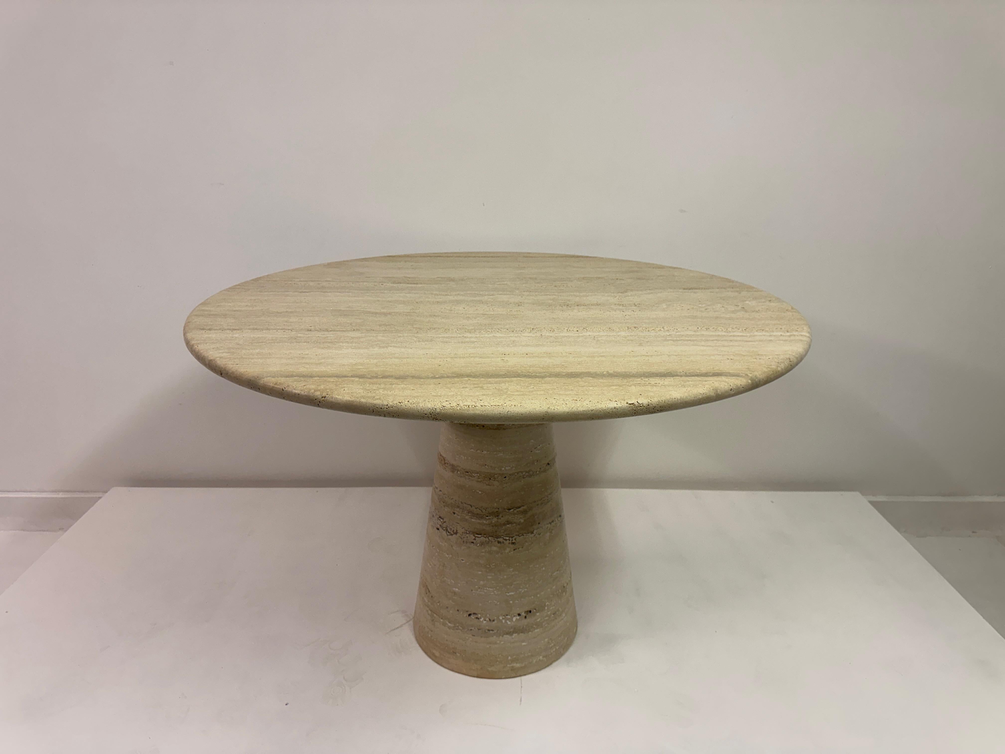 Round Travertine Dining Table by Italian Workshop in Brescia

Elegant and architectural, this round dining table is handcrafted in Brescia, Italy by a specialist stone workshop. The design features a solid conical pedestal base and a thick,