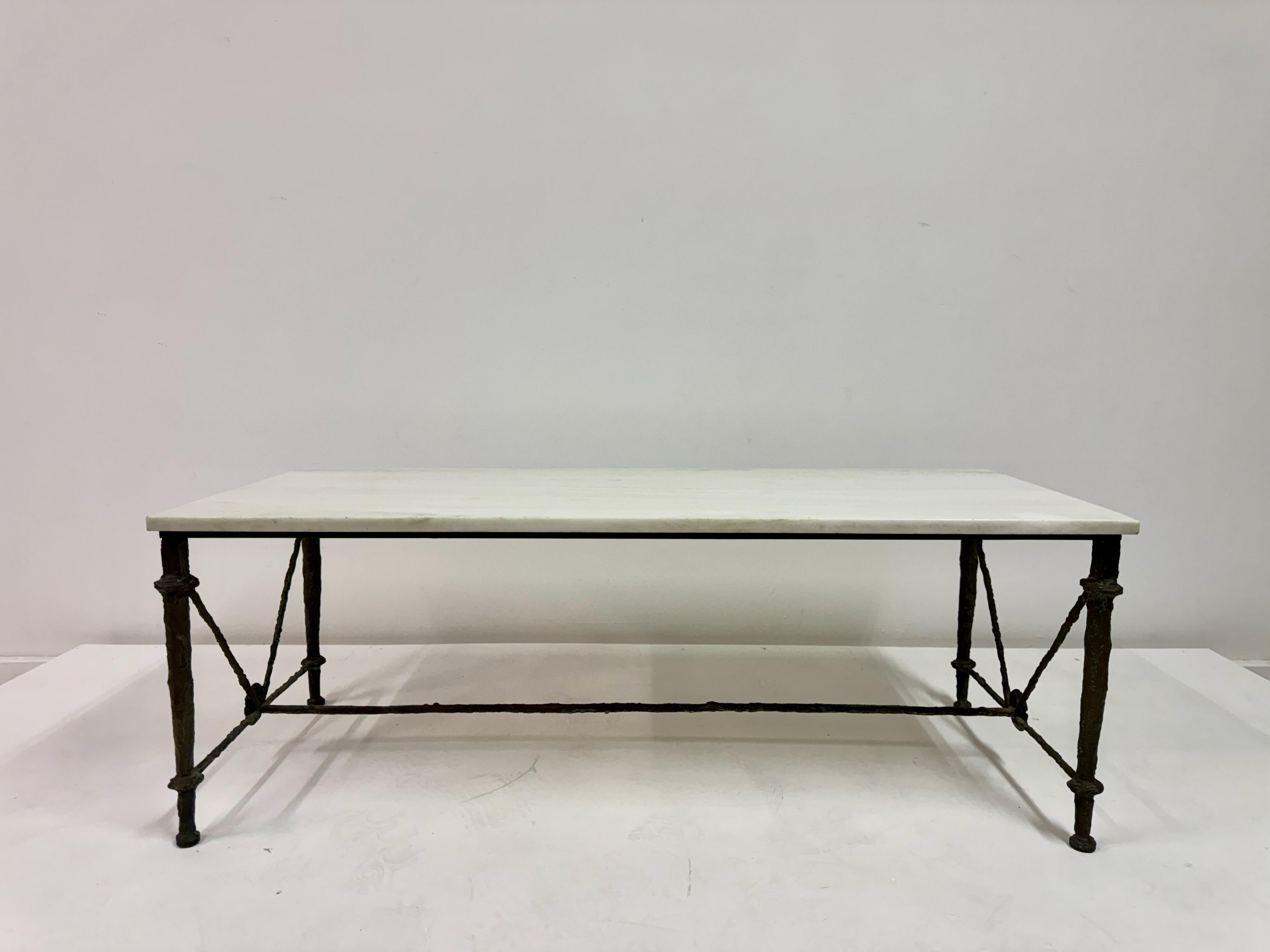 Bronze and Marble Coffee Table in the Style of Giacometti

Evocative bronze and marble coffee table inspired by the sculptural aesthetic of Diego Giacometti. The textured bronze base features delicately modelled legs with X-form stretchers and cast