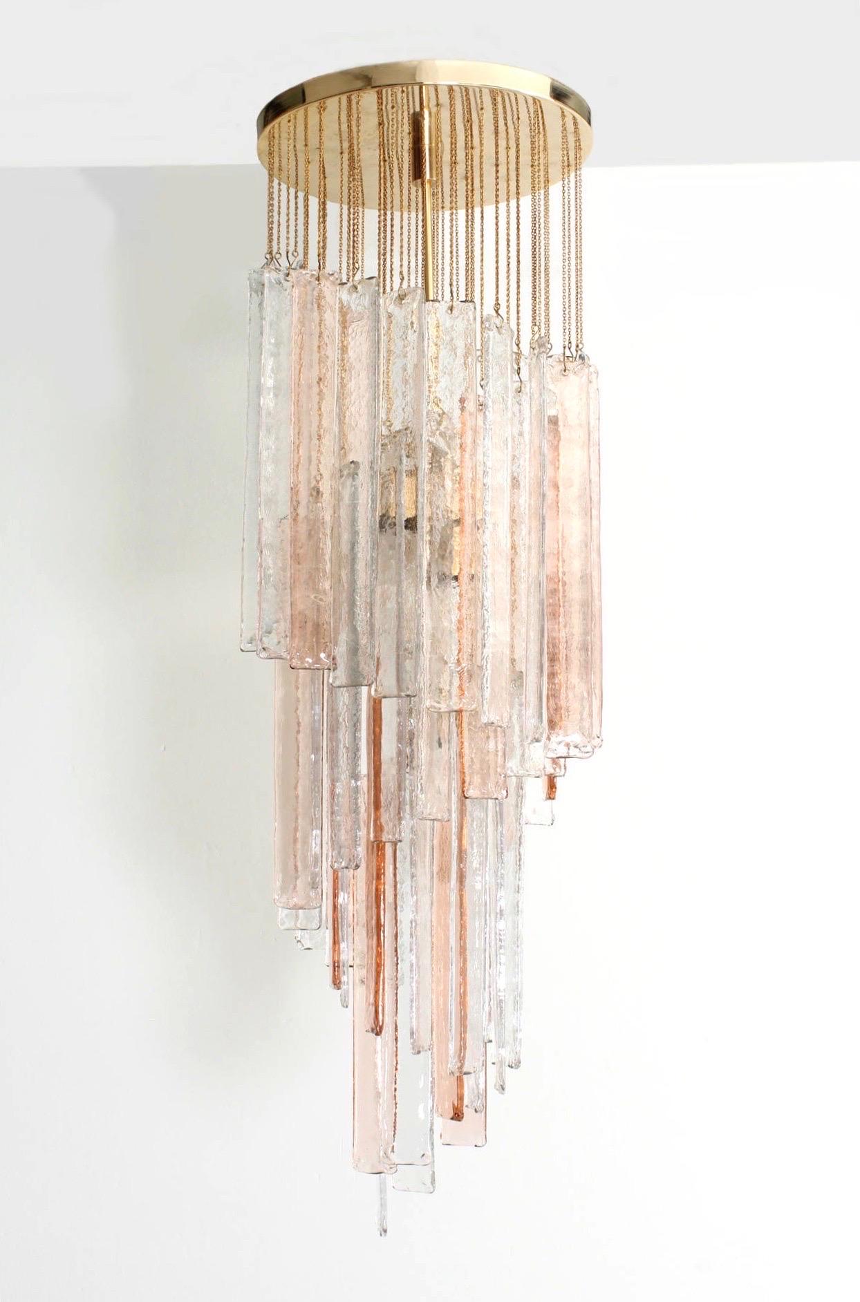 Spiral and marvellous Italian pink clear Murano glasses midcentury chandelier. This chandelier was made during the 1970s in Italy for the Venice company “Mazzega”.
Mazzega lie in the noble Venetian glassworking tradition; the firm was founded Angelo