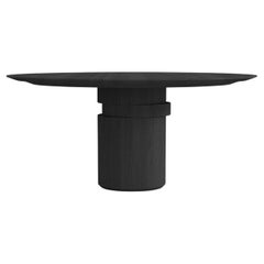Contemporary round dining table, black ash wood, shifting disc, Belgian design