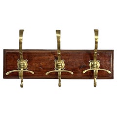 Italian Art Nouveau wall coat rack in wood and brass, 1920s