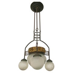 Italian Art Nouveau chandelier made of iron and brass, with original period glass