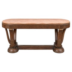 Italian Art Deco dining table with a marble top and an ornate base featuring lea