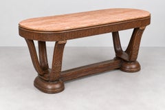 Italian Art Deco dining table with a marble top and an ornate base featuring lea