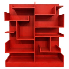 Italian red bookcase from the Rationalist period, featuring several shelves.