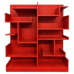 Italian red bookcase from the Rationalist period, featuring several shelves.