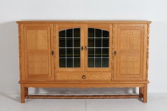 Danish Henning Kjærnulf style Long and High Sideboard of Solid carved Oak 1970s