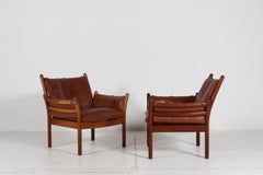 Paire de fauteuils « Genius » d'Illum Wikkelsø en bois de palissandre et cuir marron, années 1970