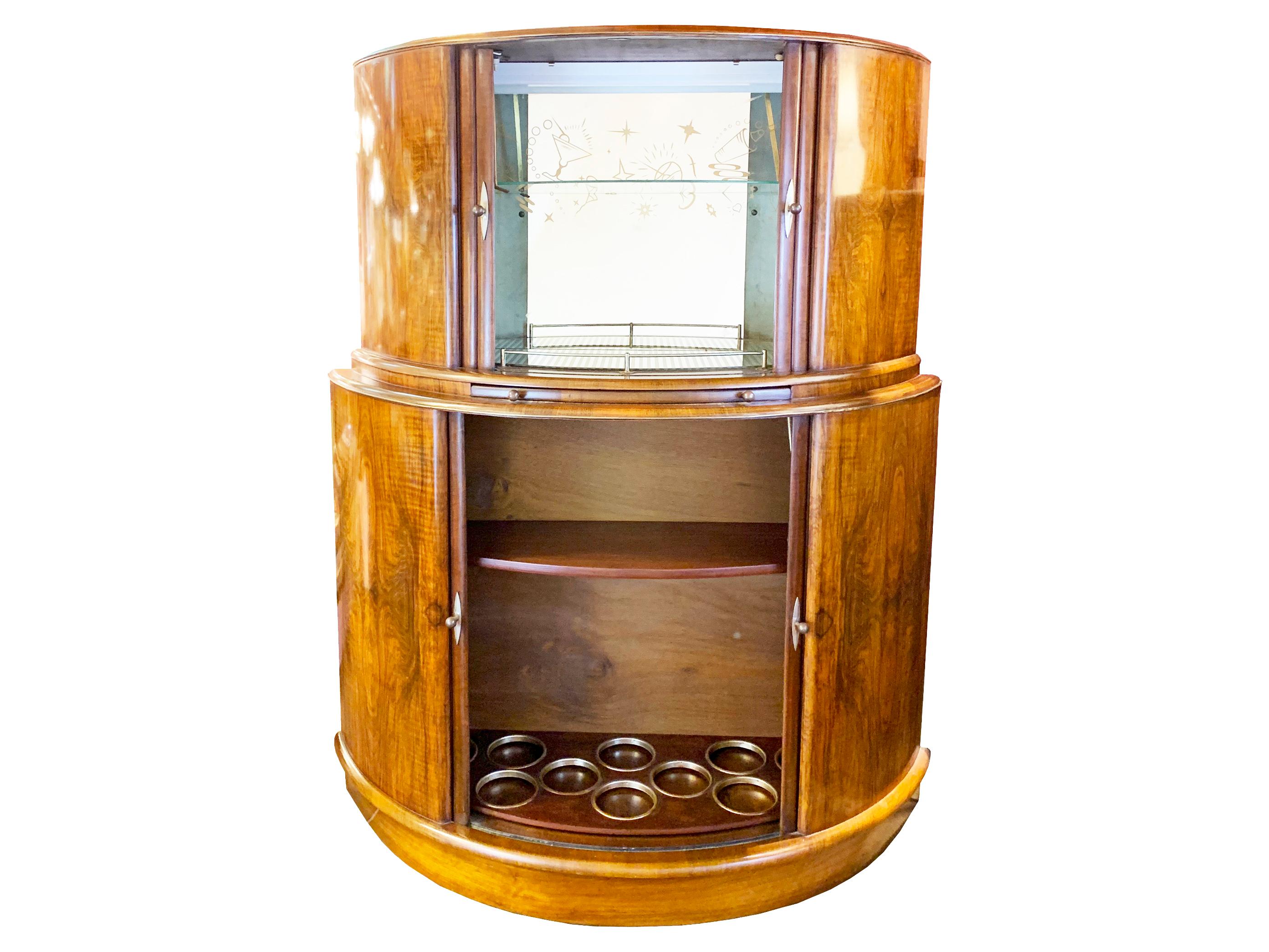  A timeless elegant Art Deco , half moon cocktail cabinet  from the 1930s crafted from walnut. With a dedicated storage area for bottles and glasses, its design is both functional and captivating.

Featuring an interior mirrored with an internal
