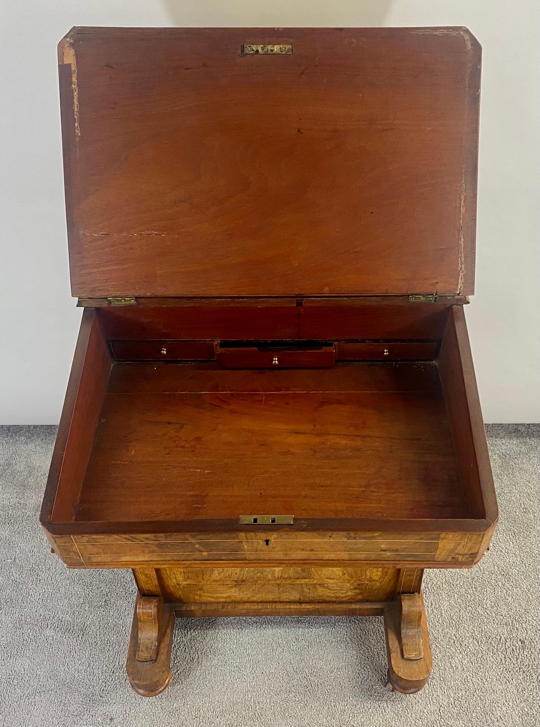Victorian Davenport desk burl inlaid over four-side drawers. The desk features dummy drawers to one side and real working drawers to the other.
The leather top is in good condition and the fitted interior line provides room to organize your desk