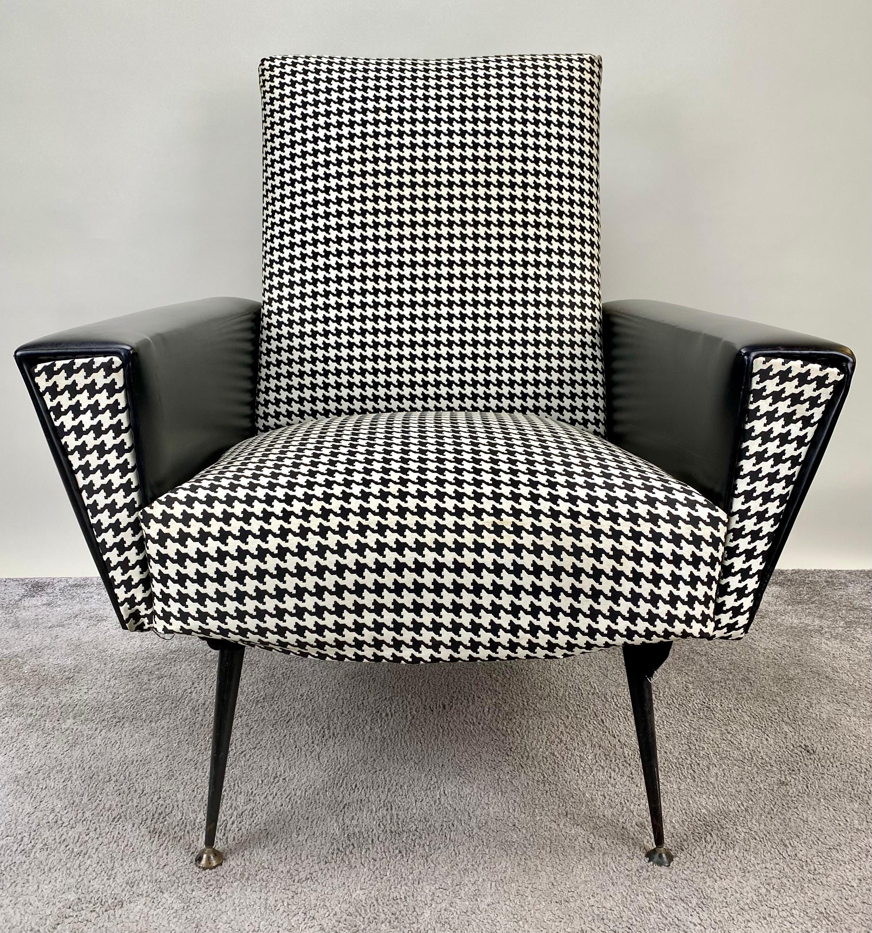 This black and white 1960's mid-century modern newly upholstered armchair is where you go to unwind, unplug, and relax. The arms are covered in black leather and it features strong back, deep seat, and curved arms and elegant.

Dimensions: 34