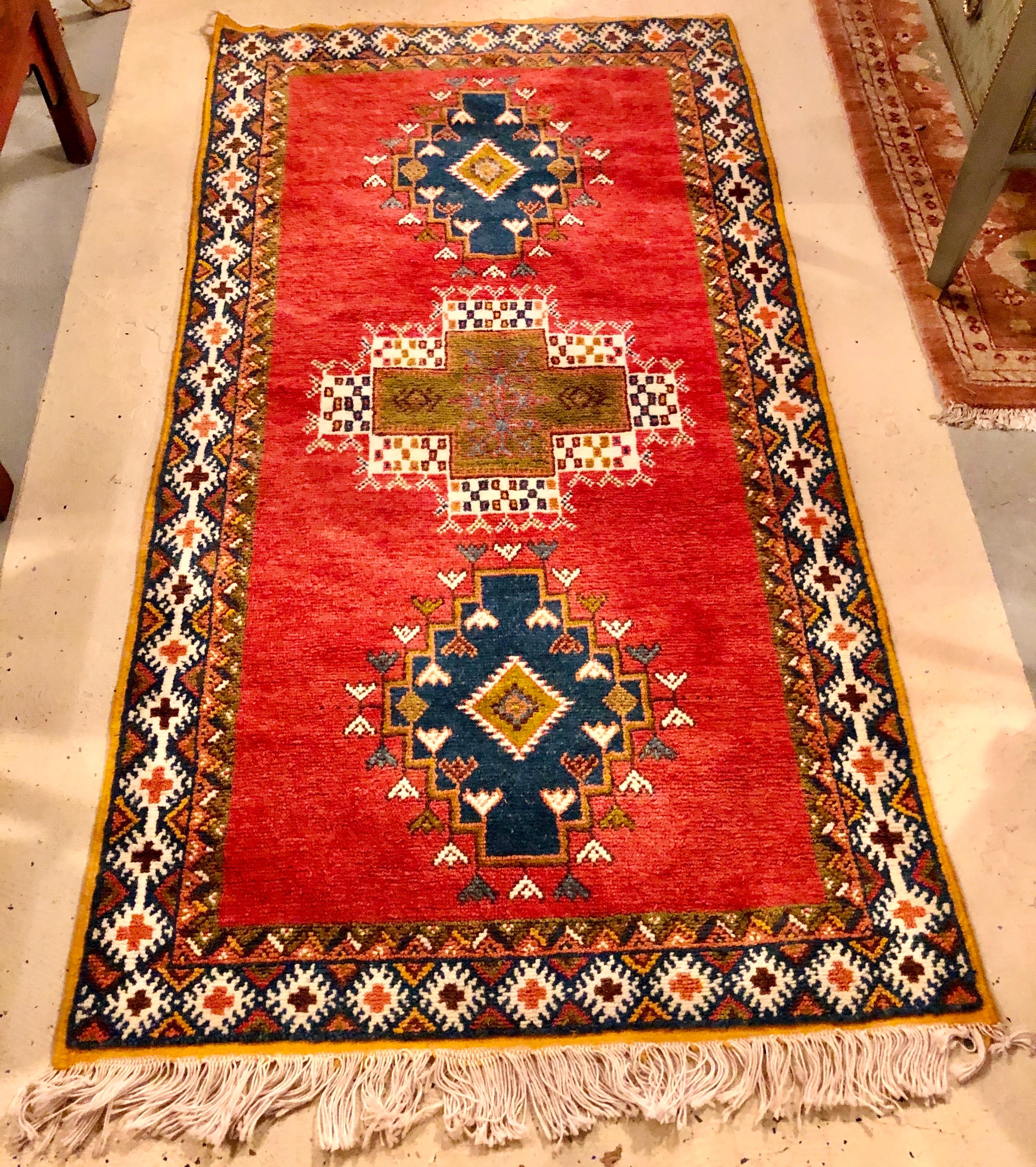 Moroccan Tribal Rug or Carpet with intricate Designs and Organic Dye. The rug is handwoven carpet by tribal women in the Taznacht region of Morocco using the highest-quality 100% sheep's wool. It features deep and vivid all-natural vegetable dyes