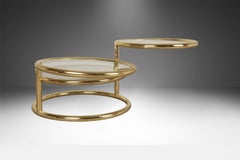 Mid Century Modern Brass Glass Swivel Coffee table in the style of Milo Baughman