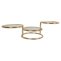 Mid Century Modern Brass Glass Swivel Coffee table in the style of Milo Baughman