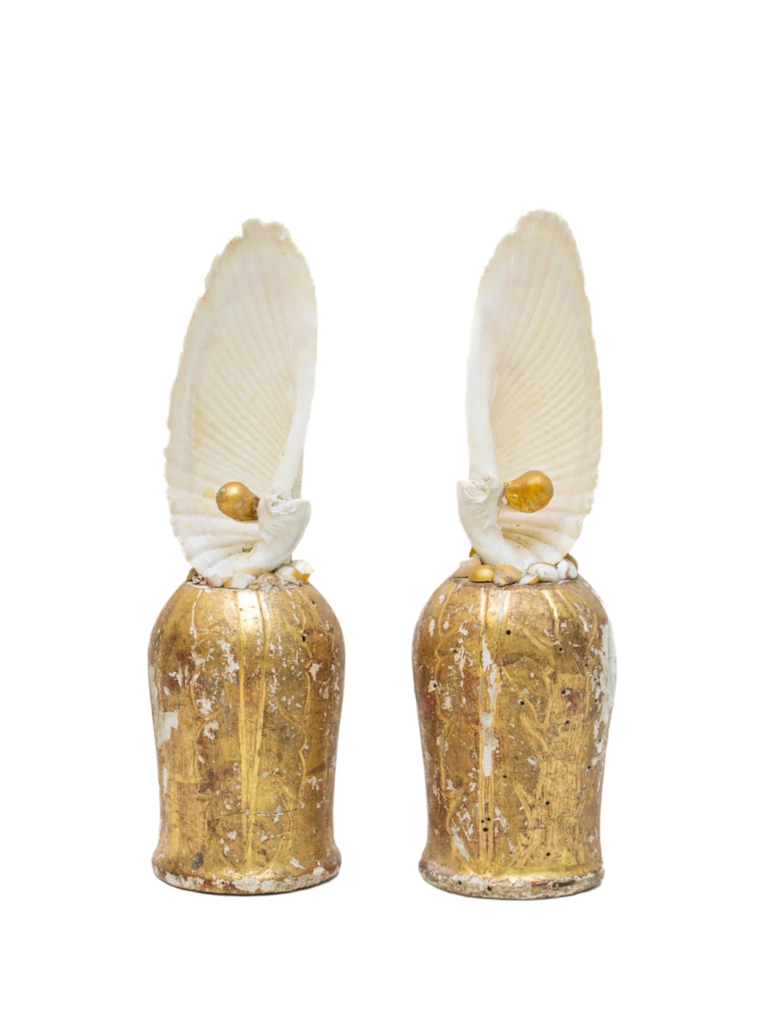 A pair of 18th century Italian gilded and hand-carved bases with two matching angel wing shells and adorned with coordinating natural forming baroque pearls. The hand-carved, gold leaf bases were originally part of a candlestick from a church in