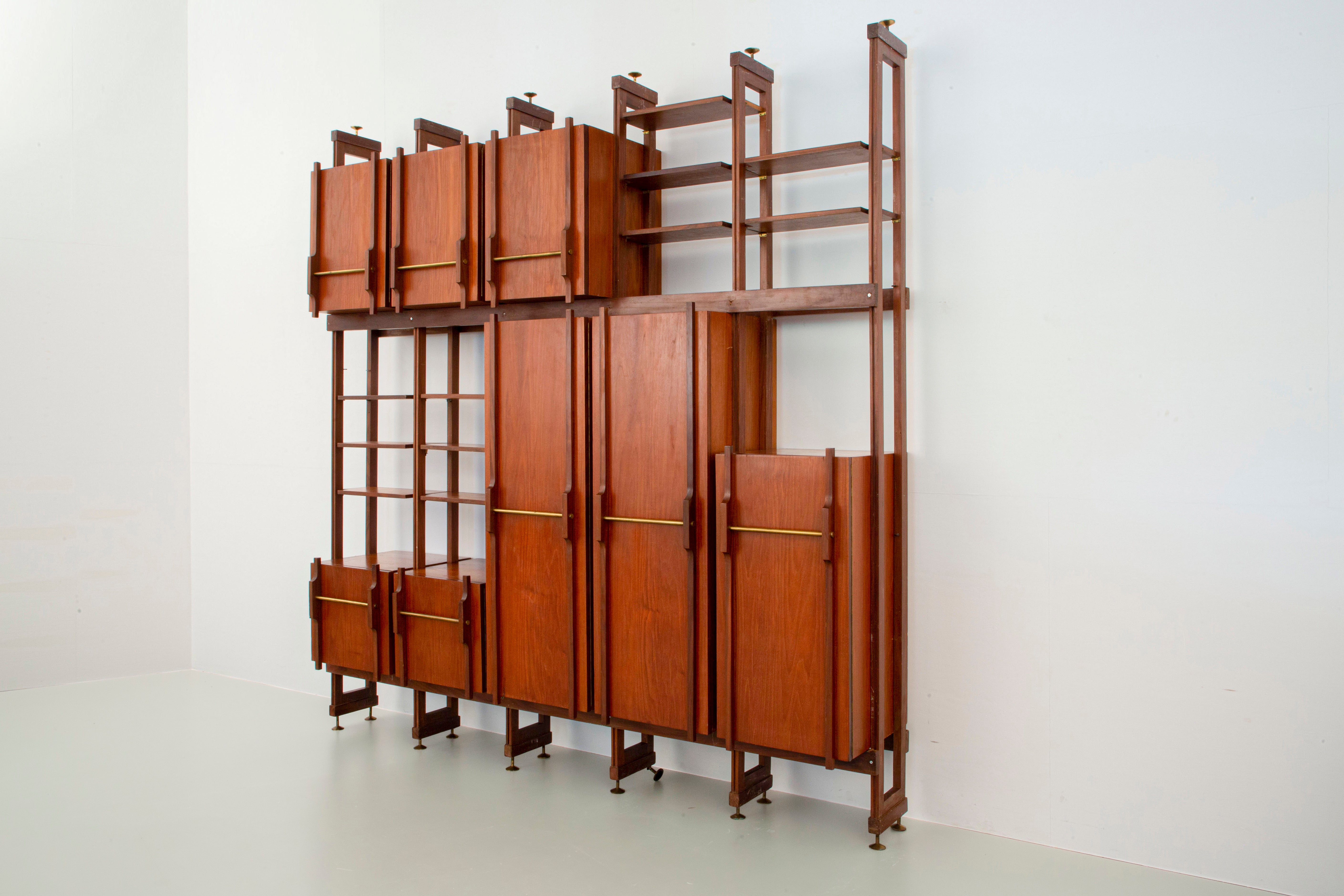 Library / Wardrobe in teak, walnut and brass, Italy, 1960's

We are very proud to add this large library / wardrobe to our collection. With the use of different kinds of wood a warm and playful atmosphere is created. The wardrobe consists of 5