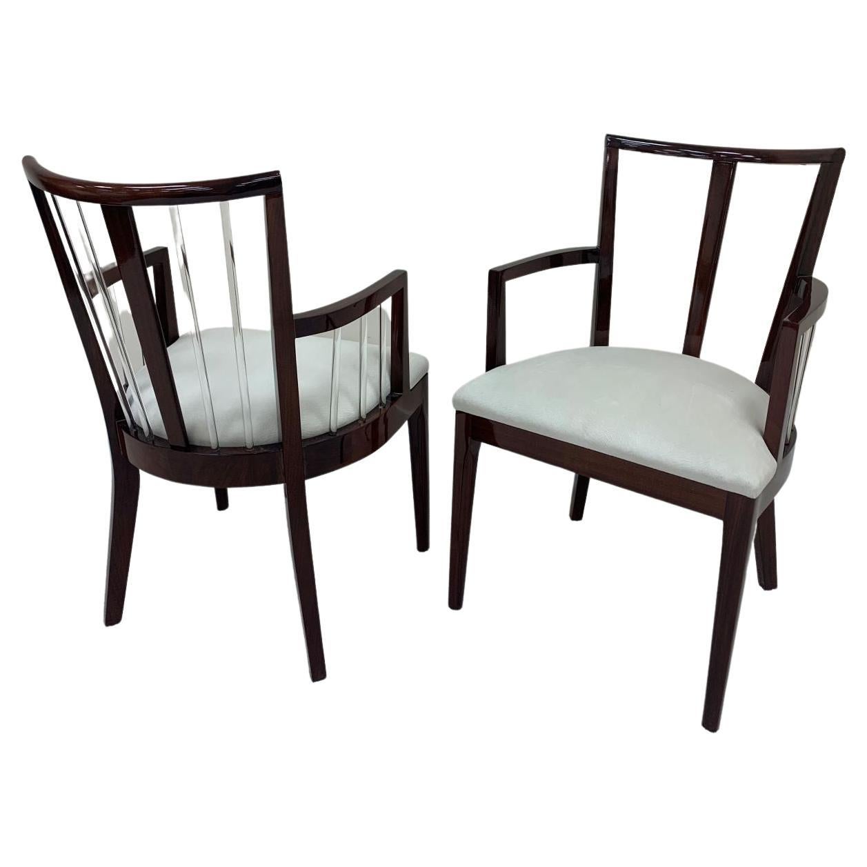 Set of six Art Deco dining chairs in the style of Grosfeld House. Unique design with solid glass rod elements in a solid mahogany frame complimented with faux pony skin upholstery. Professionally and beautifully restored. Set includes 2 Captain’s
