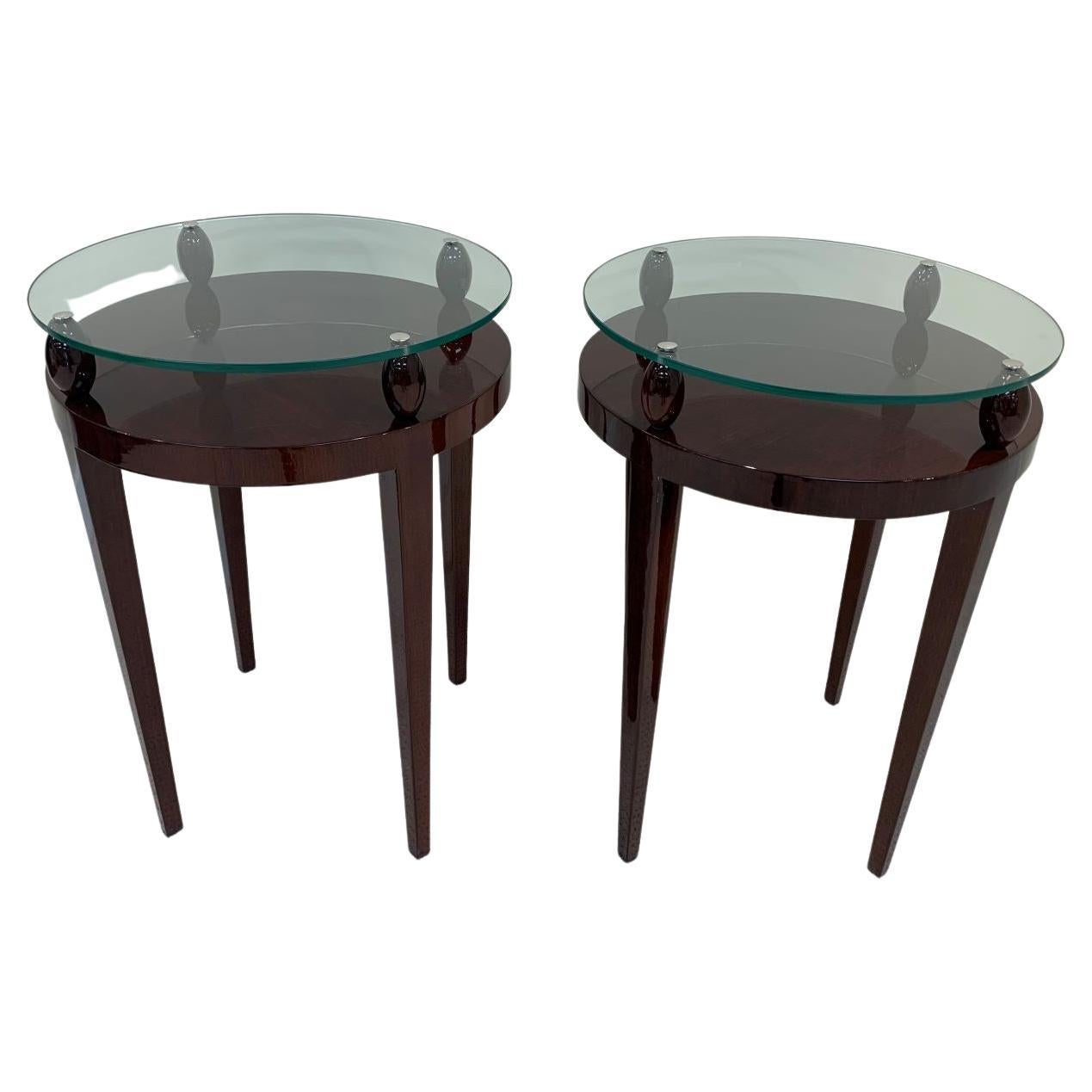 Stunning pair of Art Deco glass-top end tables. Professionally and beautifully restored solid walnut tables with 3/8” thick glass that floats on oval shaped walnut finials. Very rare and unusual tables from the period. Measures: Height 27.75 inches 
