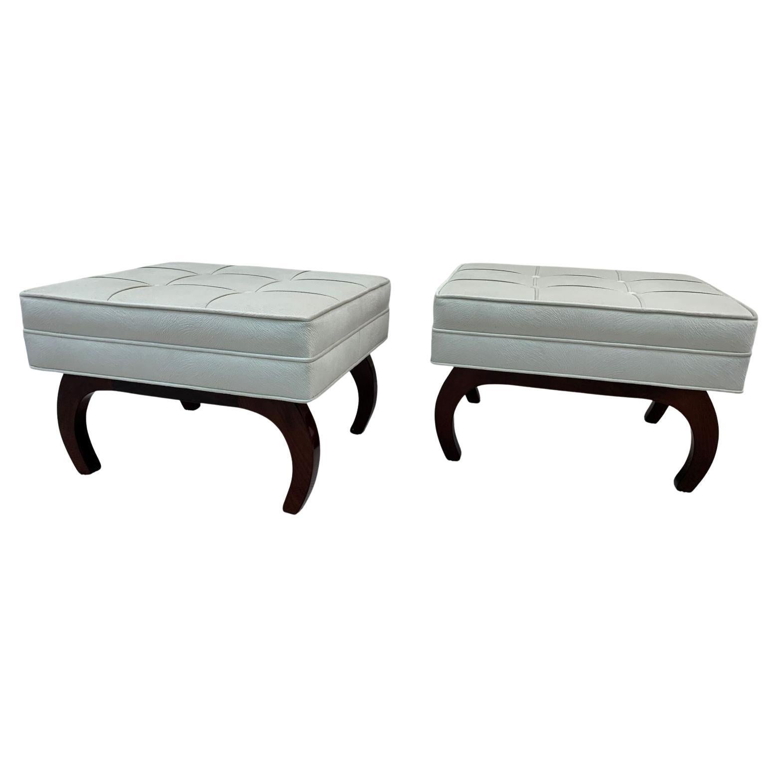 Pair of French Art Deco benches with solid walnut bases. A tailored and tufted look make these benches a perfect fit for any seating purpose. The faux pony skin upholstery is a nice compliment to the curved-leg walnut bases. Measures: Width 22.5,