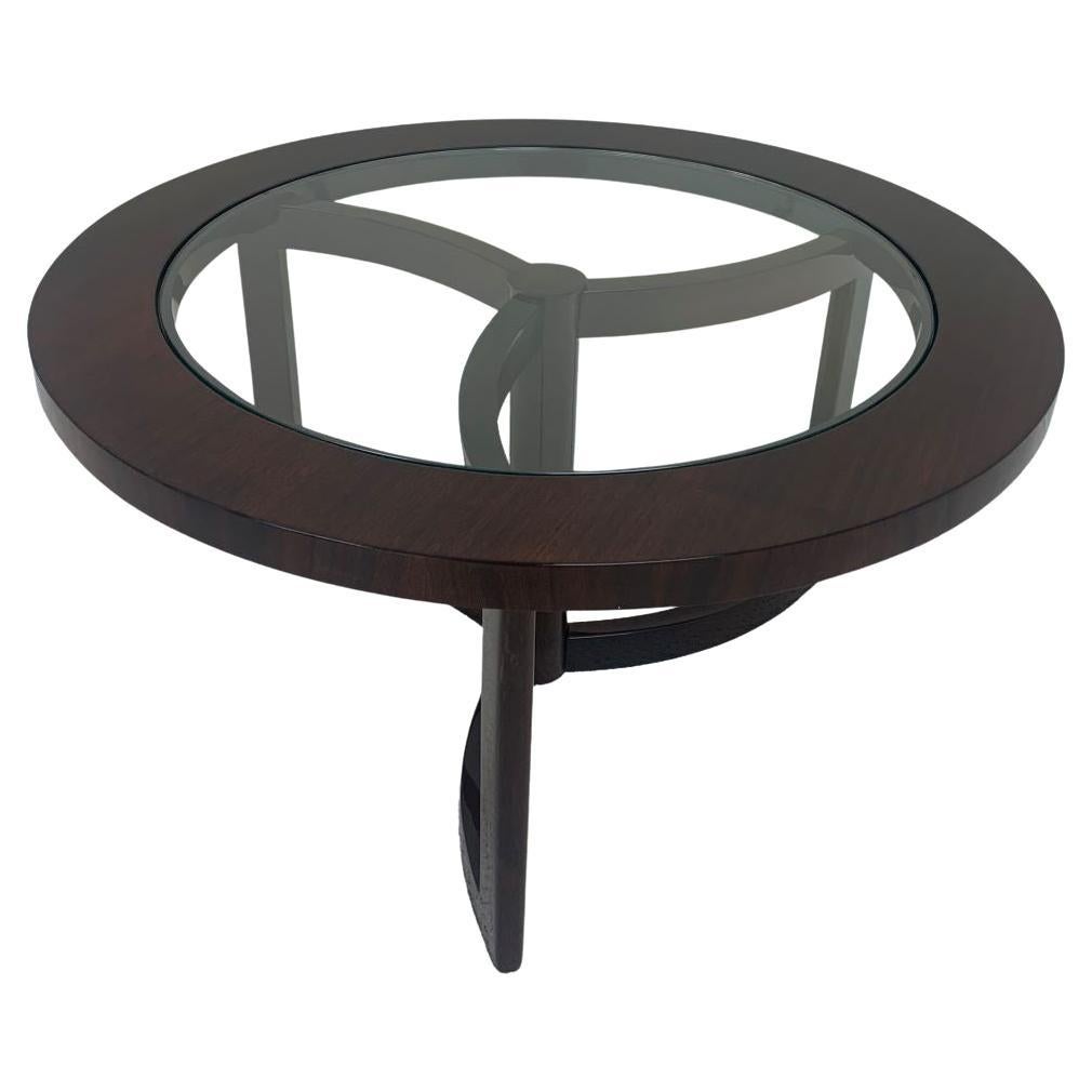 Very stylish Mid-Century Modern round walnut and glass top Art Deco cocktail table. Unusual and hard to find pinwheel design. All finished in a beautiful clear gloss with a hand rub finish. Dimensions 30 inch diameter top 16 high. The glass is 23