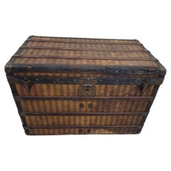 This magnificent striped steamer trunk from the Louis Vuitton brand mixes  solid brass and leather