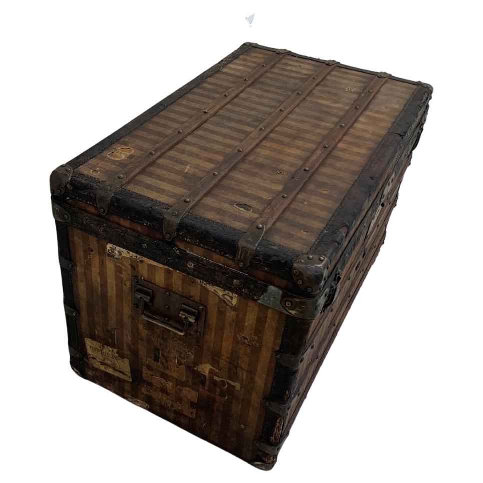 A rare Louis Vuitton striped canvas trunk with leather trim and brass fittings; Circa 1870-1880's.The trunk has the woven striped canvas outside with all compartments intact and original Louis Vuitton paper tag on the inside. These early models are