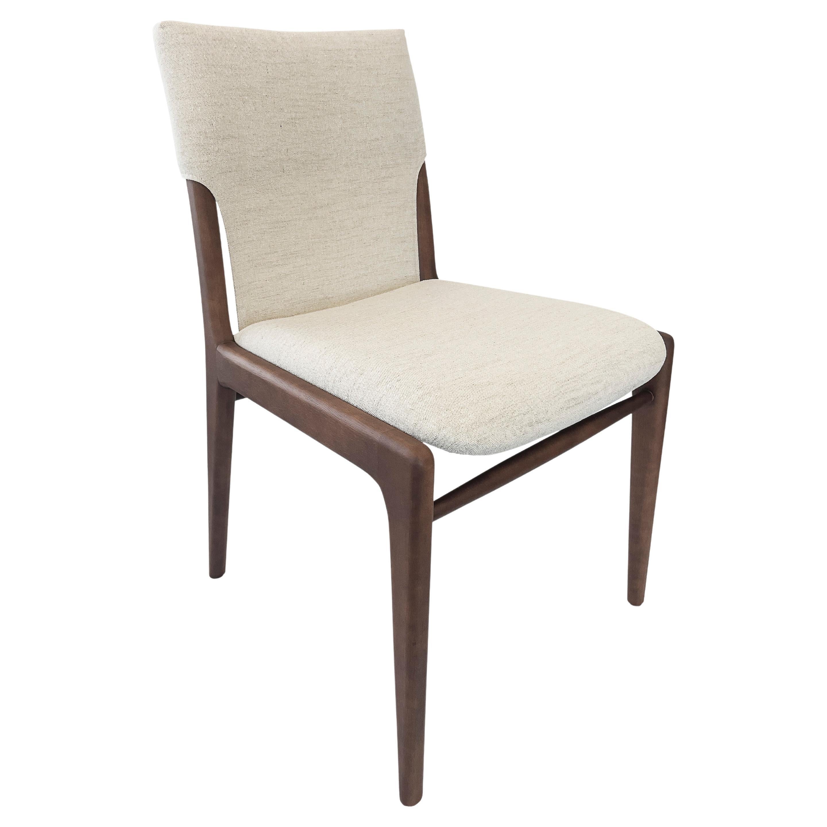 Legendary Uultis designer Mr. Sergio Batista has created the Tress dining chair in a light beige fabric upholstered and a walnut wood finish. His creations are synonymous with style, elegance, comfort, and quality. With the Tress chair, Mr. Batista