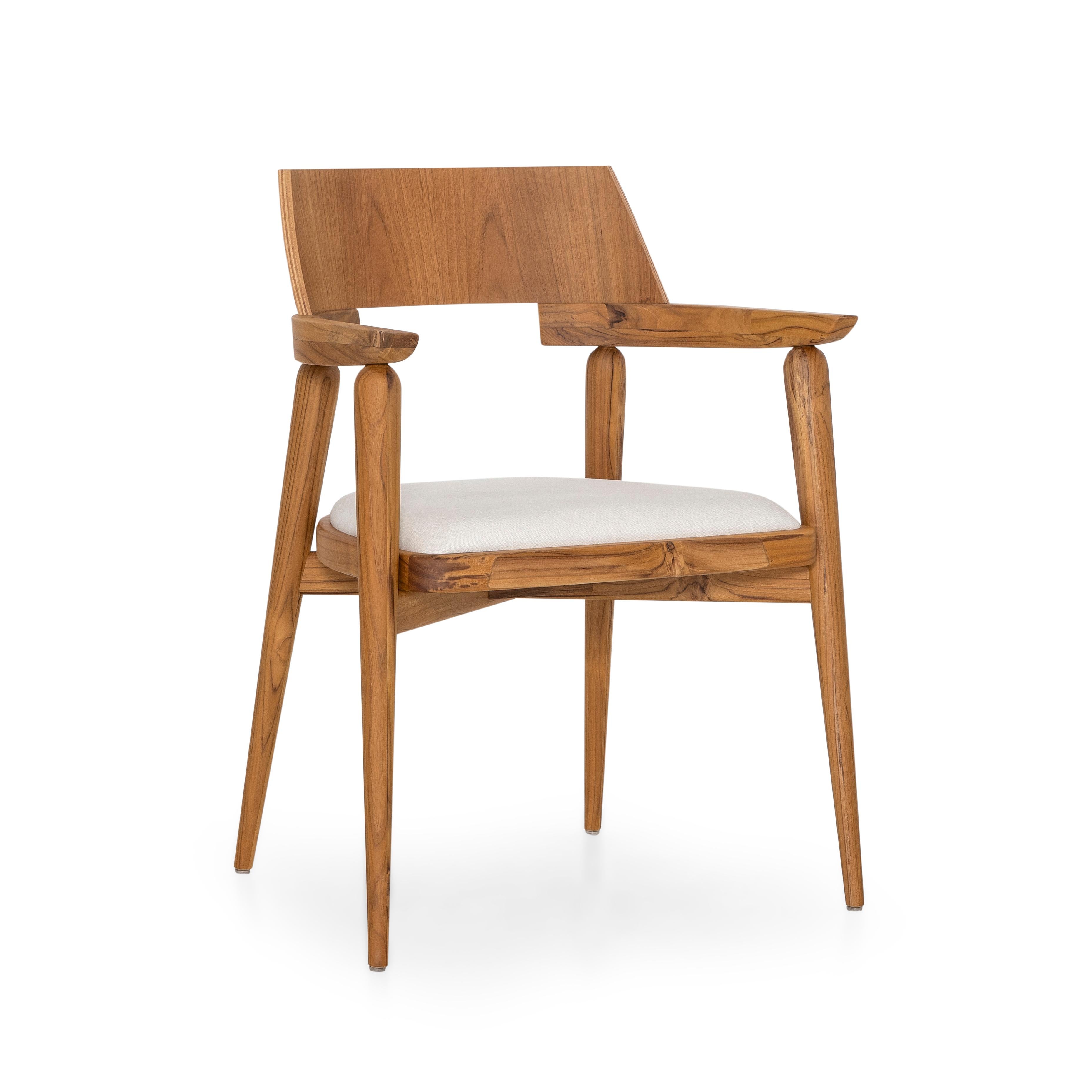 A Bone chair designed by Sérgio Batista for Uultis in teak with white fabric. The Bone chair blends sculptural elegance with everyday functionality in a beautifully balanced design. Crafted with a solid teak frame, its warm natural tones highlight