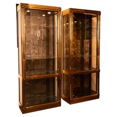 Mastercraft Brass Vitrine Cabinets with black detailing, a pair