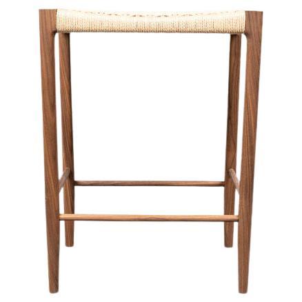 Featuring a mortice and tenon frame and handwoven seat, the Papyri Stool is artisan-crafted from recyclable paper cord, and sustainably harvested walnut.

The seat features a continuous run of Danish paper cord woven around 