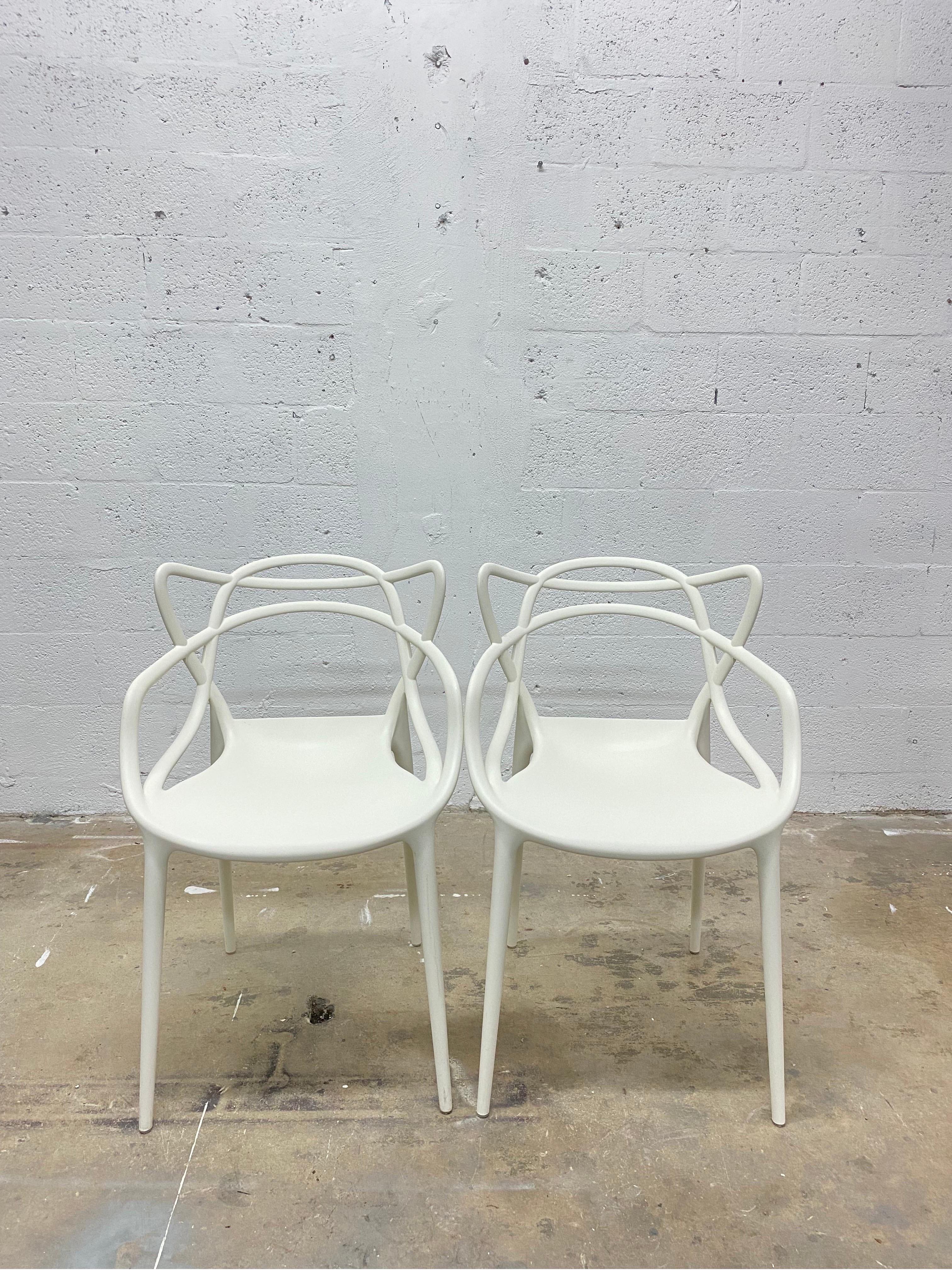 Pair of white masters chairs by Philippe Starck and Eugeni Quitllet for Kartell.

Philippe Starck and Eugeni Quitllet pay homage to three different midcentury-modern masters in one sleek, versatile indoor-outdoor seat. The Masters Chair (2010)