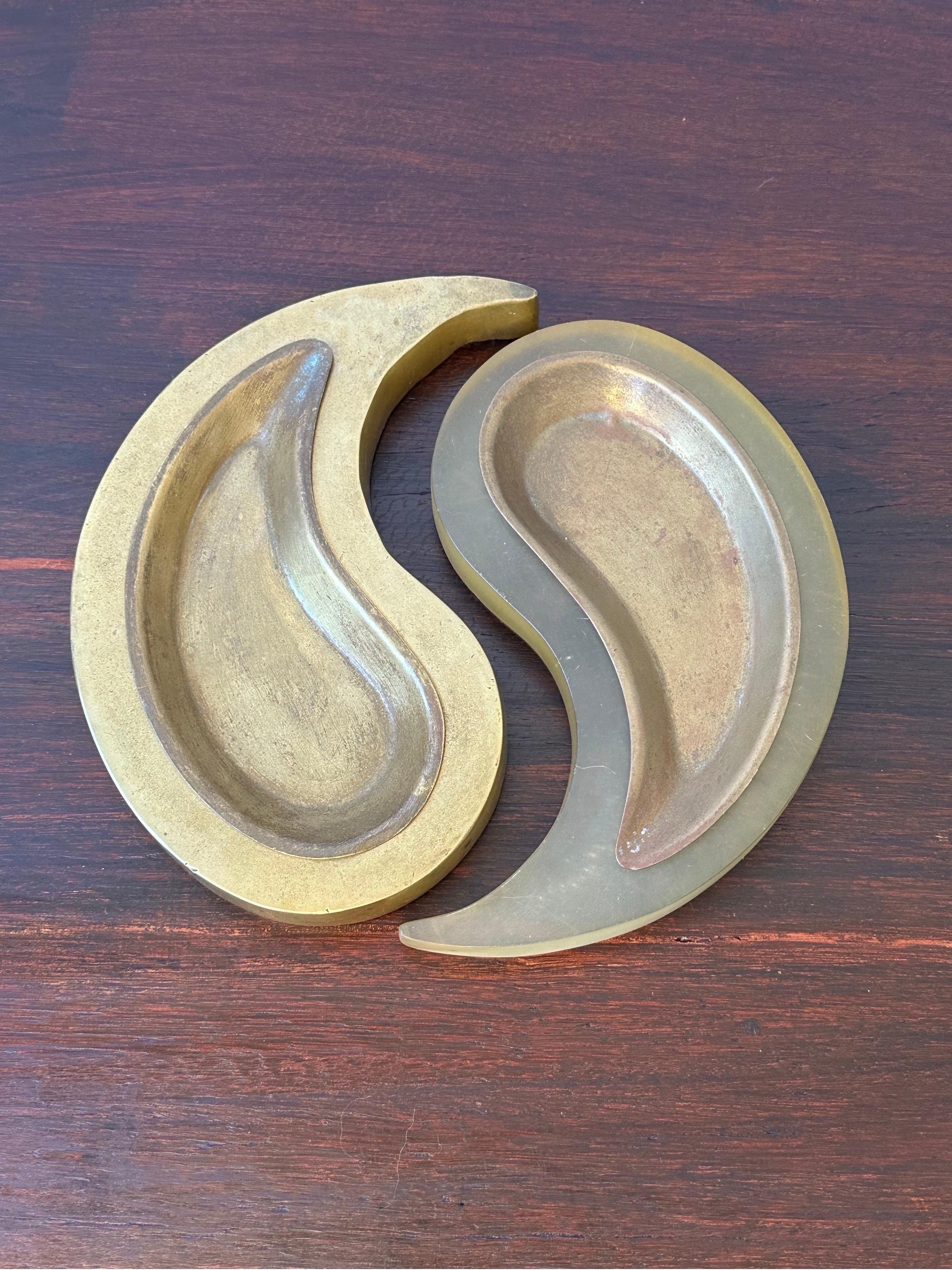 Brazilian modern ashtray or catch all with two interconnecting pieces representing yin and yang.  One part is solid bronze while the other is acrylic and both have removable bronze trays.