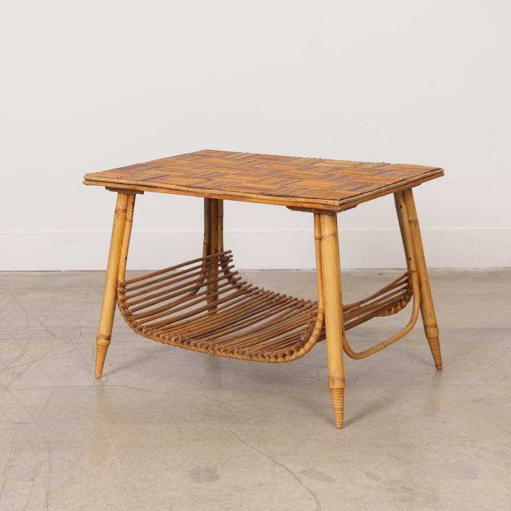 Unique rattan side table by Adrien Audoux and Frida Minet from France, 1960s. Rectangular rattan top with checked pattern surface and lower magazine rack on four bamboo legs with wrapped rattan detailing. All original rattan finish shows age,