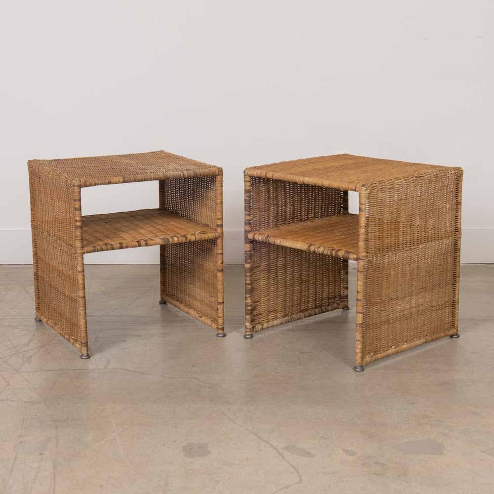 Great pair of wicker side tables from France. Metal frame fully wrapped in woven wicker shows nice age and patina. Functional lower shelf makes these perfect as nightstands or end tables. 