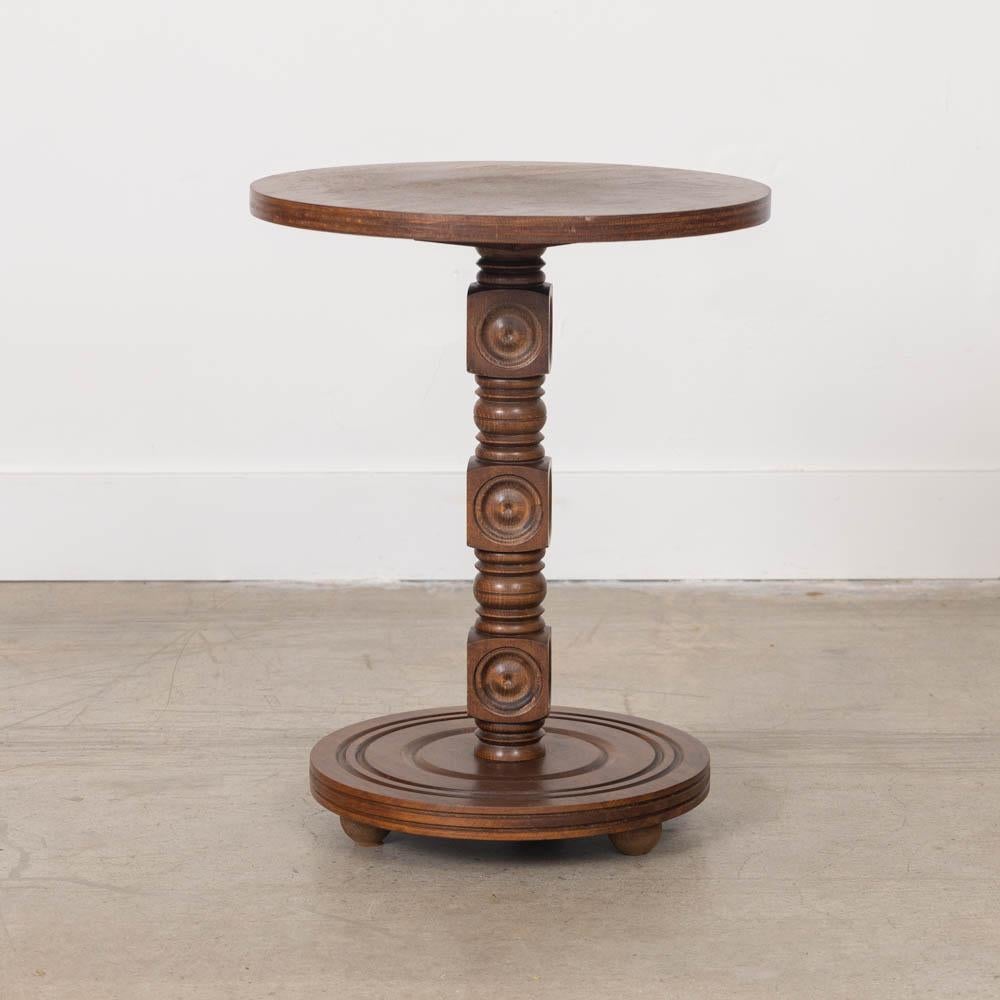 Petite carved wood table by Charles Dudouyt, made in France, 1940s. Thick carved wood block stem with circular top and base. Base has etched ring detail and rests on three rounded feet. Original wood finish shows nice age and patina with some