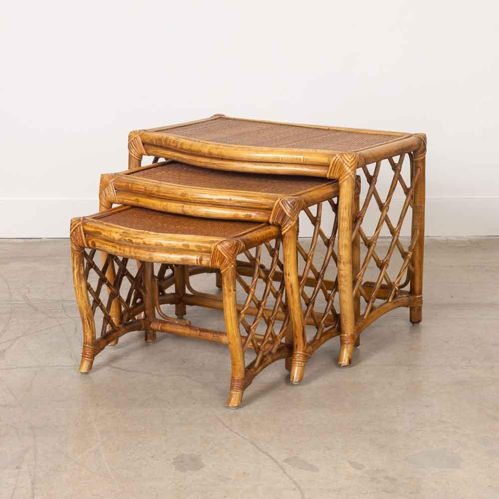 Lovely set of 3 rattan nesting tables from France, 1960s. Bamboo and rattan frame with lattice detail on the sides. Beautiful and unique set. 

Measures: 
Large table: 18.5
