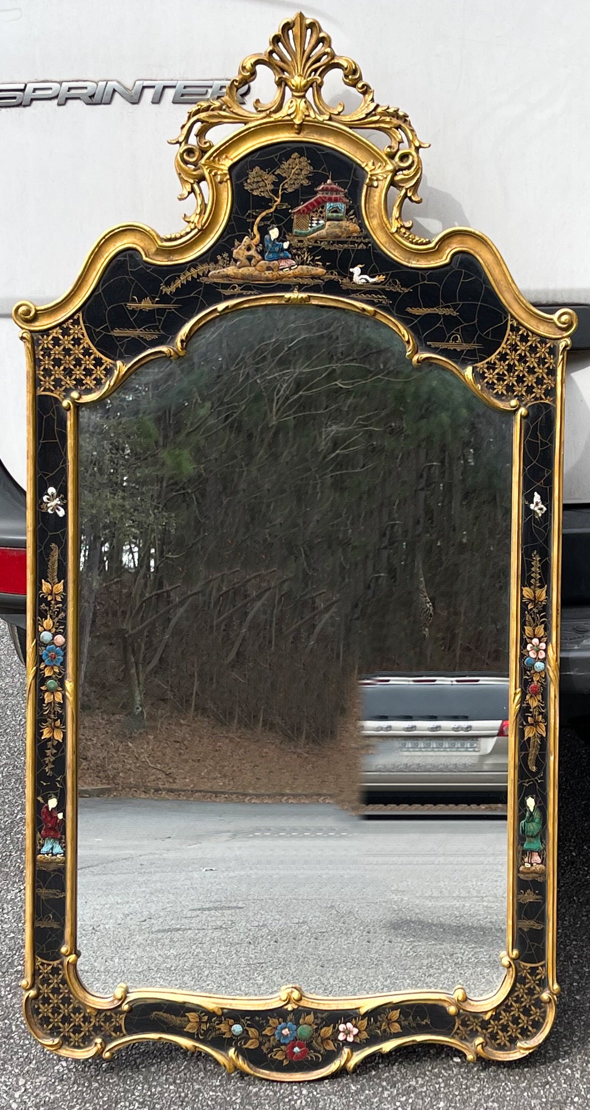 This is a lovely pair of chinoiserie mirrors with carved giltwood frames. They date to the 1960s and are Italian with pastoral chinoiserie scenes. They are unmarked.