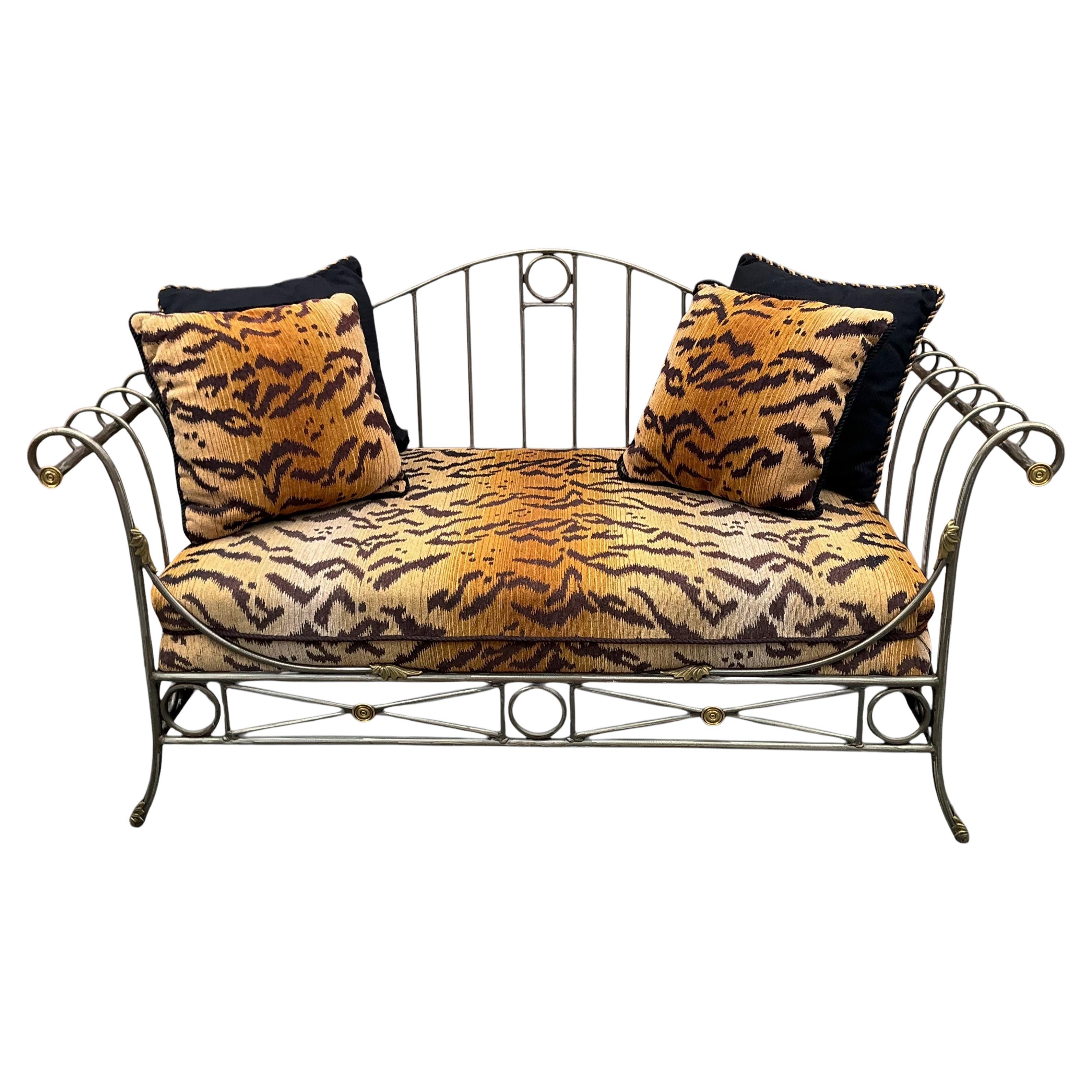 This is late 20th century French Maison Jansen style steel and brass neo-classical daybed. The tiger velvet cushion and pillows could be Scalamandre, but I have no way of knowing for certain. It is in very good condition. The frame is steel and
