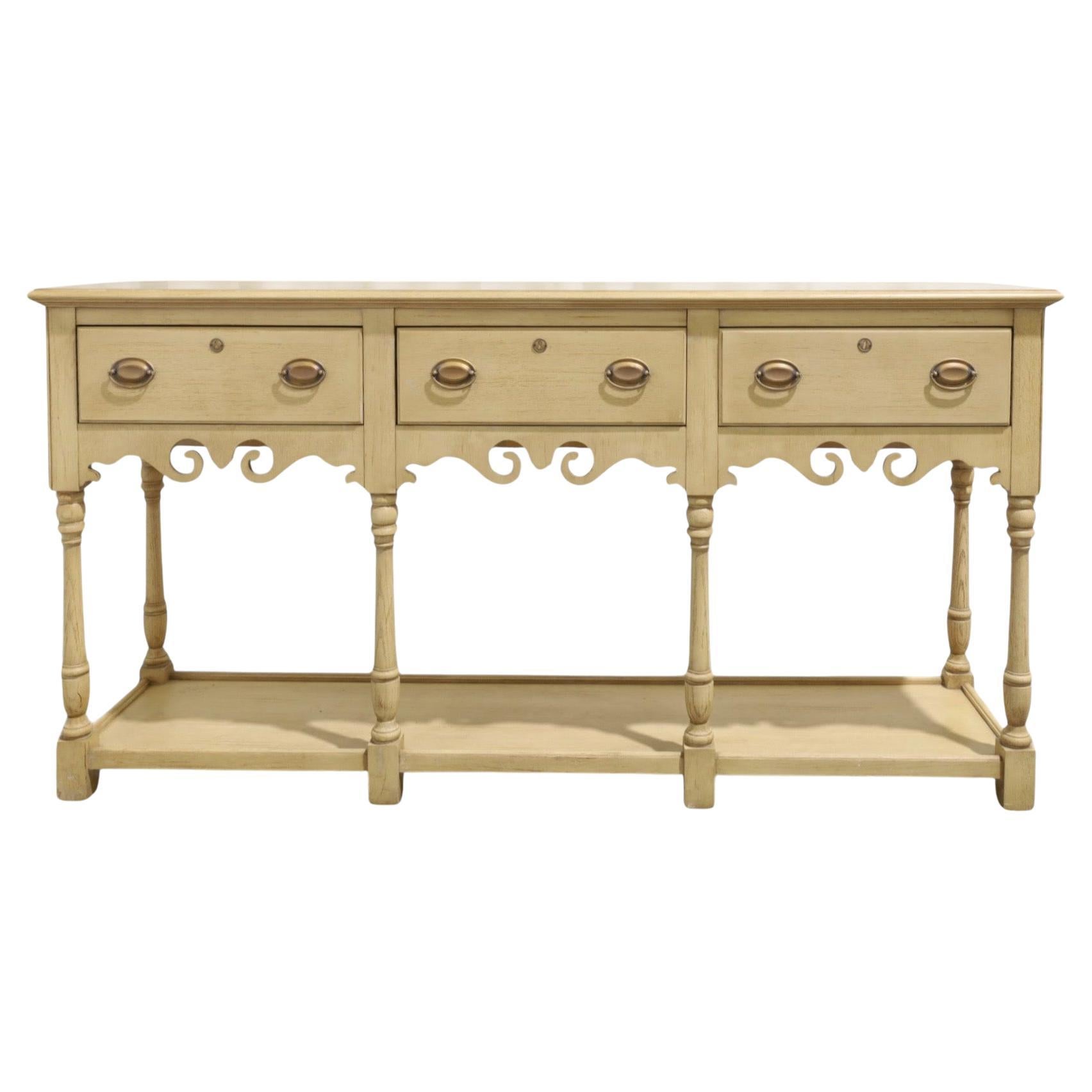 This is a cerused oak sideboard with sort of an English country home look. It is by Century and in very good condition. It has brass farmhouse inspired hardware and a wonderfully carved apron. It is a very versatile piece.