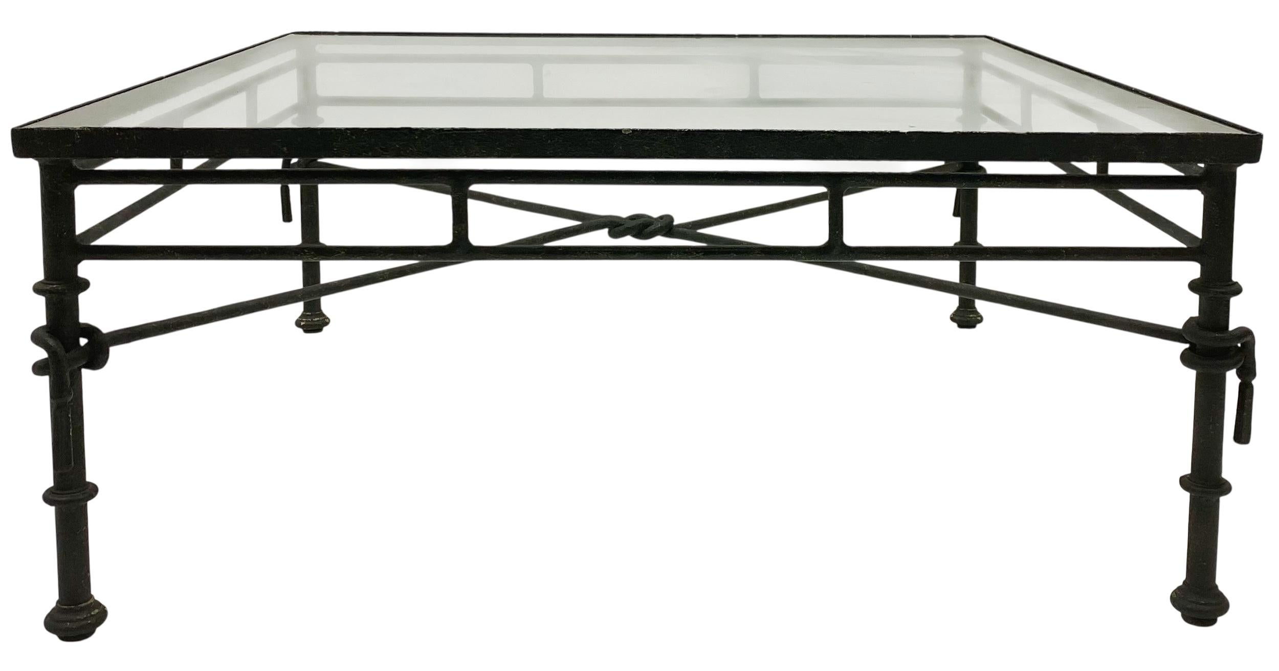 This is a sculpted metal square coffee table is a series of twisted knots and bulbous joints that is reminiscent of  the famous surrealist sculptor, Giacometti. The glass top is in very good condition, and this clean line style enables it to work