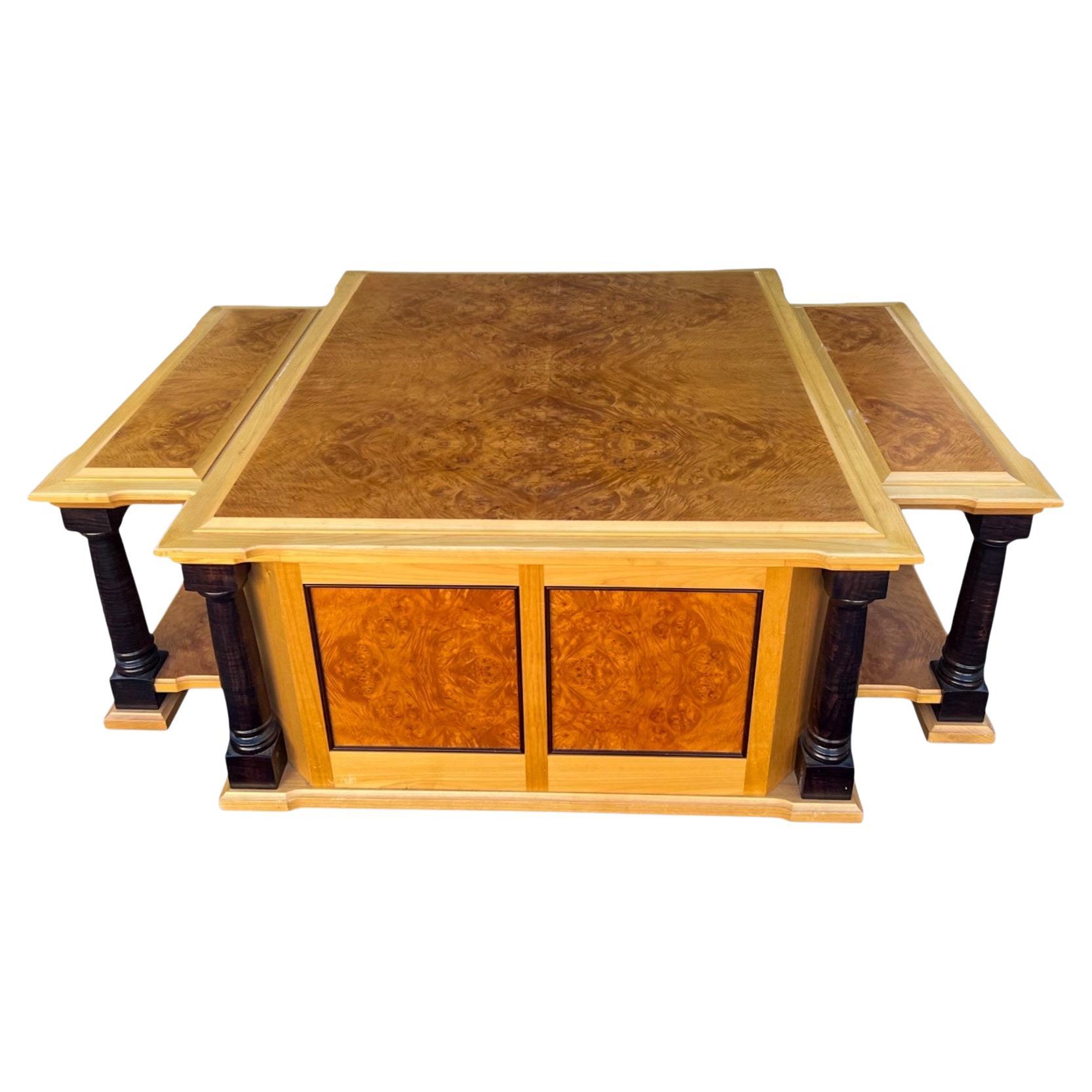This is a large scale neo-classical style custom coffee table. It is hand hewn from chestnut burl and maple with ebonized columns. The lid comes off revealing substantial storage. It is a handsome piece!
