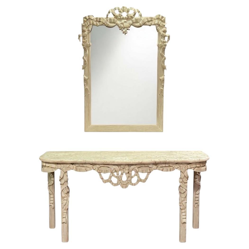 This is a large scale carved Italian mirror with ribbon foliate on both the mirror and table. It is carved wood. The top of the console table is cast stone and is attached. Mirror is 48”L x 60”H. The set most likely dates to the 1970s and is