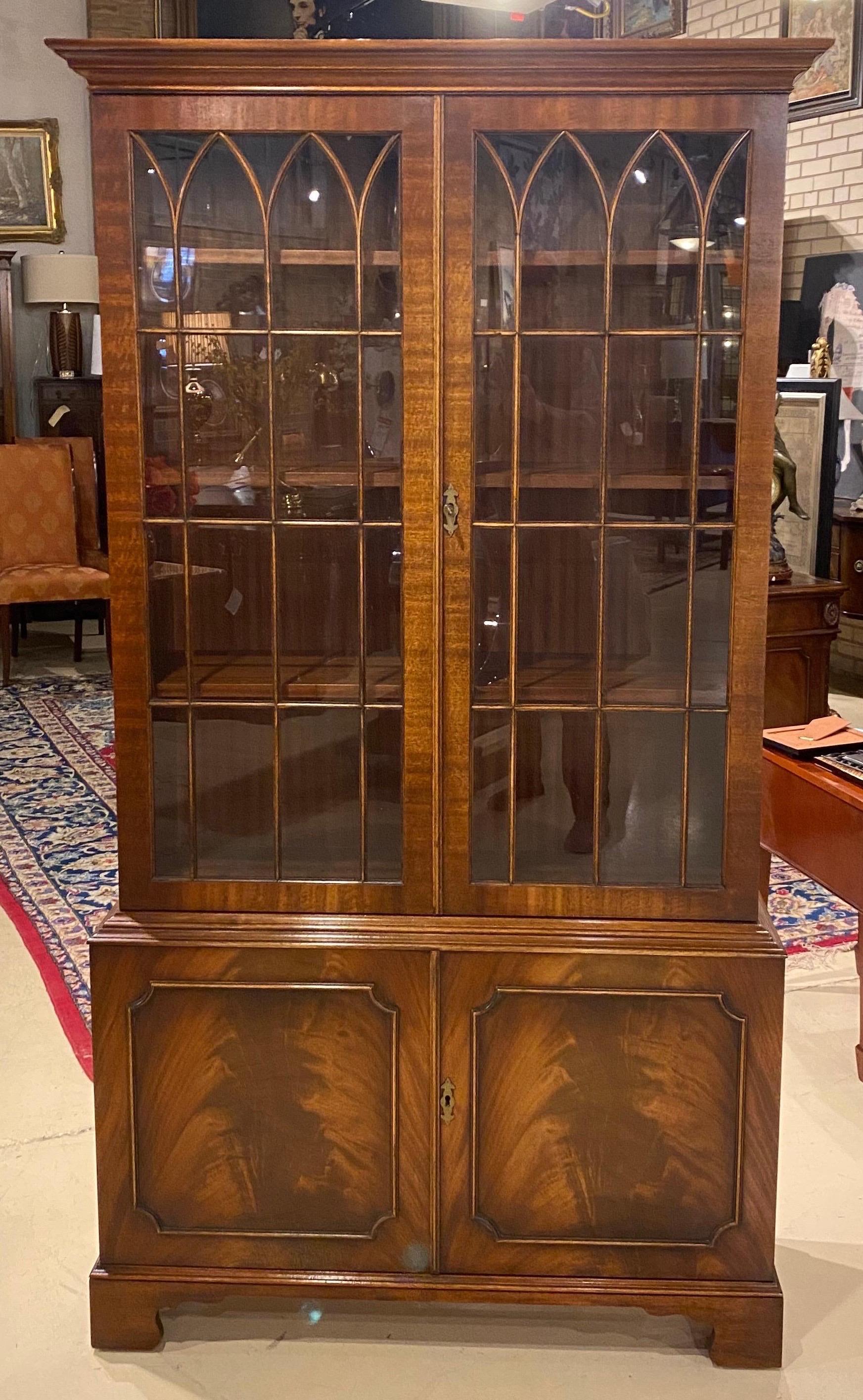 A quite lovely English bookcase made by Bevan Funnell one of England's better known cabinet shops of the 20th century. A handsome piece of a more compact scale that will add a dash of English character to any room. Two hand glazed doors as well as